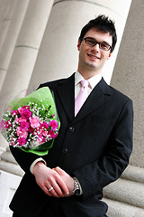 Image showing Happy man with flowers under his arm