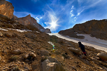 Image showing Weary hiker ascent to mountain pass in evening