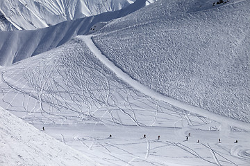 Image showing Snowboarders and skiers on groomed slope