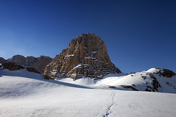 Image showing Snowy plateau and footpath against rock and blue sky in nice day