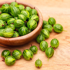 Image showing Close-Up Of Gooseberries In Vintage Wooden Bowl On Wooden Table