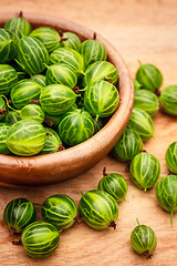 Image showing Close-Up Of Gooseberries In Vintage Wooden Bowl On Wooden Table