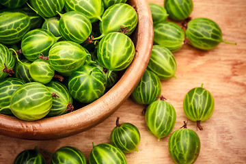 Image showing Close-Up Of Gooseberries In Vintage Wooden Bowl On Wooden Table