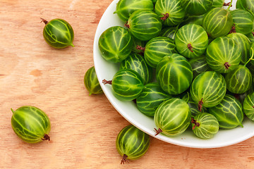 Image showing Close-Up Of Gooseberries In Vintage White Dish On Wooden Table