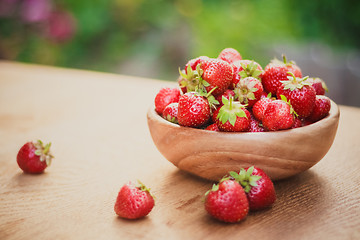 Image showing Close-Up Of Strawberries In Vintage Wooden Bowl On Table