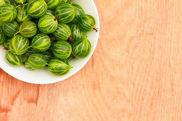 Image showing Close-Up Of Gooseberries In Vintage White Dish On Wooden Table