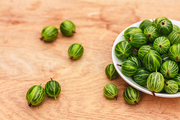 Image showing Close-Up Of Gooseberries In Vintage White Dish On Wooden Table