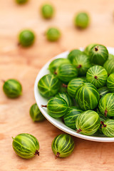 Image showing Close-Up Of Gooseberries In Vintage White Dish On Wooden Table