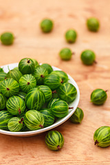 Image showing Close-Up Of Gooseberries In Vintage White Dish On Wooden Table