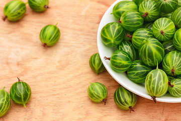 Image showing Close-Up Of Gooseberries In Vintage White Dish On Wooden Table