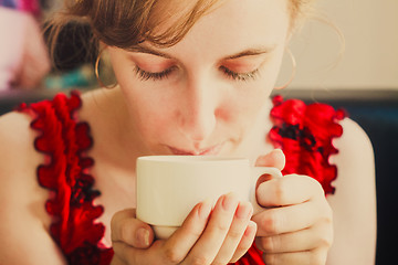 Image showing Female Hands Holding A Cup