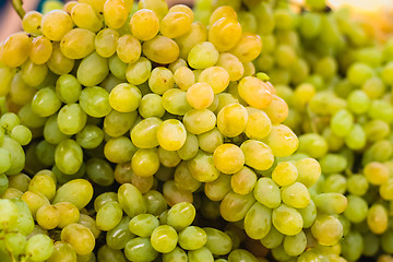 Image showing Fresh green grapes pile on the local market.  Crop Background