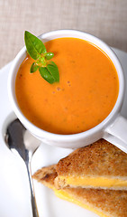 Image showing Delicious bowl of tomato soup with grilled cheese sandwich