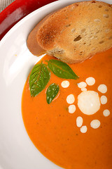 Image showing Delicious bowl of tomato soup with grilled bread and basil