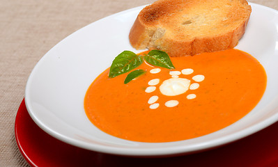 Image showing Delicious bowl of tomato soup with grilled bread and basil
