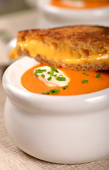 Image showing Delicious bowl of tomato soup with grilled cheese sandwich