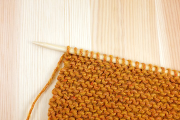 Image showing Garter stitch in orange yarn on a knitting needle