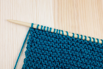 Image showing Garter stitch in teal yarn on knitting needle