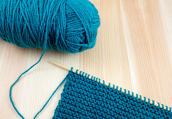 Image showing Ball of blue wool with knitting on the needle