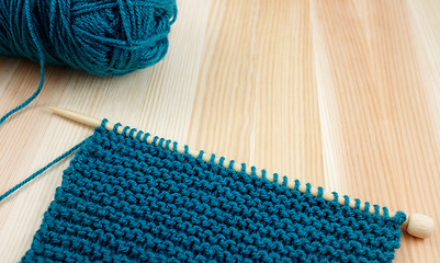 Image showing Garter stitch on knitting needle with teal yarn