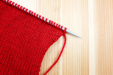 Image showing Stocking stitch in red wool on a knitting needle