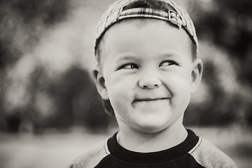 Image showing Happy child wearing striped cap in outdoor portrait