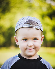Image showing Happy child wearing striped cap in outdoor portrait