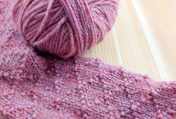 Image showing Patterned knitting with ball of pink yarn