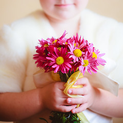 Image showing Little Girl With Pink Flowers Asters In Their Hands