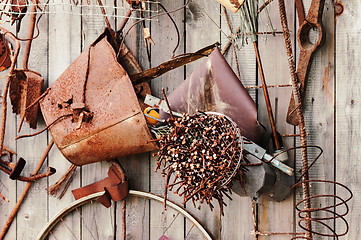 Image showing Still-life of rusty metal items on wooden background.