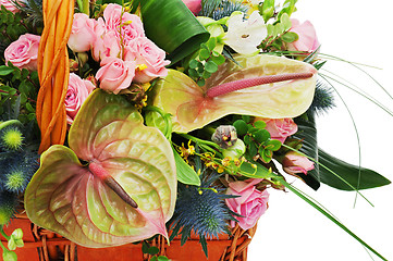 Image showing Fragment of flower bouquet in wicker basket isolated on white ba