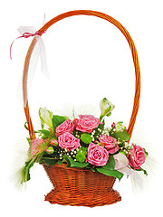 Image showing Colorful flower bouquet from roses in wicker basket  isolated on