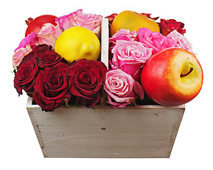 Image showing Flower arrangement of red roses and fruits in wooden basket isol