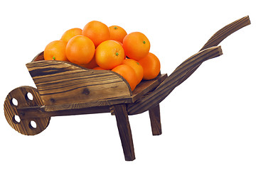 Image showing Oranges on pushcart  isolated on white.