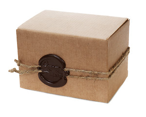 Image showing brown cardboard box with stamp isolated on white background 