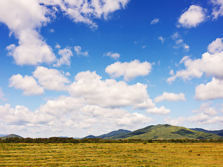 Image showing Landscape with mountain views, arable land, blue sky and beautif