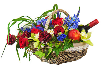 Image showing Flower arrangement of roses, orchids, fruits and bottle of wine 