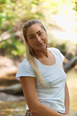 Image showing Outdoor fashion portrait of fine woman looking up. 