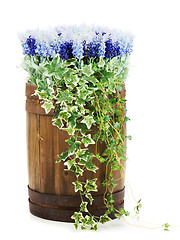 Image showing Composition of artificial flowers in old wooden barrel isolated 