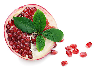 Image showing Pomegranate fruit with green leaves isolated on white background