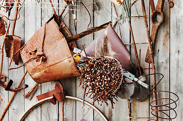 Image showing Still-life of rusty metal items on wooden background.