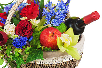 Image showing Flower arrangement of roses, orchids, fruits and bottle of wine 