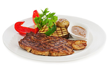 Image showing Grilled steaks, baked potatoes and vegetables on white plate.