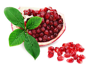 Image showing Part of pomegranate fruit with green leaves isolated on white ba