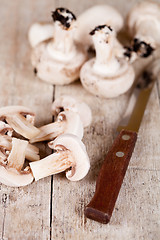 Image showing  fresh sliced champignons and old knife 