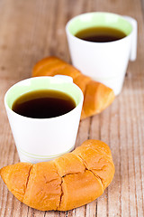 Image showing two cups of tea and fresh croissants