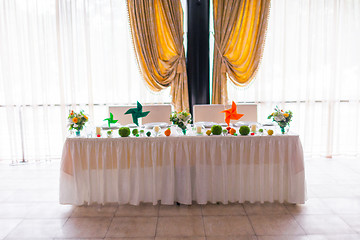 Image showing tables decorated with flowers and fruit