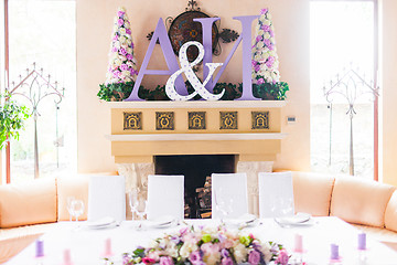Image showing Bride and groom's table decorated with flowers