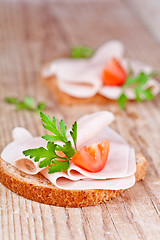 Image showing bread with sliced ham, fresh tomatoes and parsley 