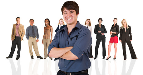 Image showing Young businessman standing in front of a business people group